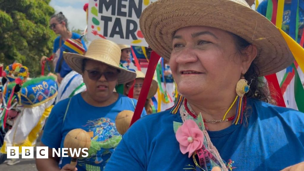Loud and colourful crowds march outside UN climate summit